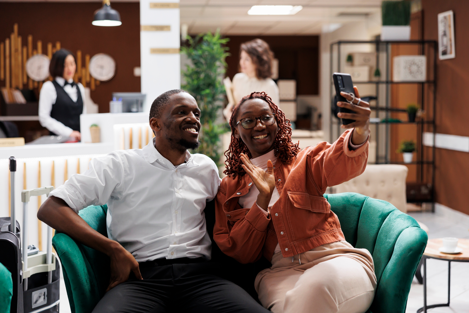 Happy couple taking a selfie in a hotel lobby
