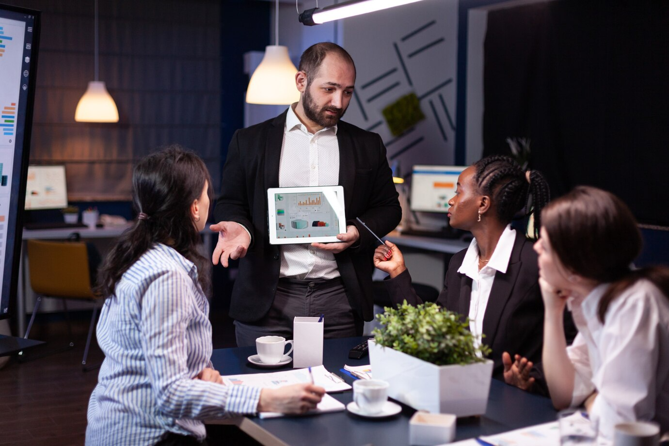 Team discussing business plan with tablet